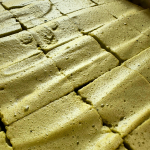 Matcha Marshmallows cut into squares on a baking tray